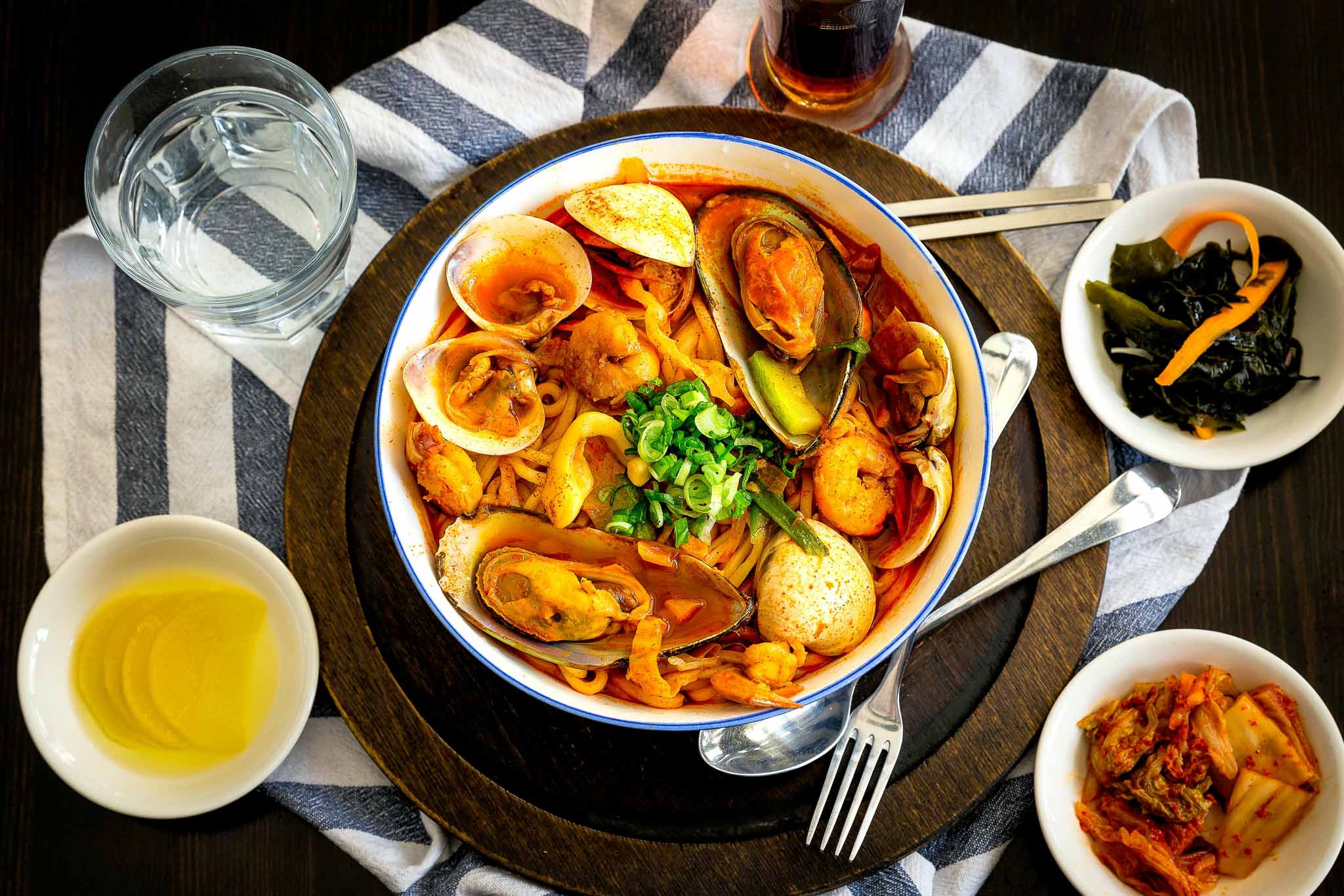 Nourishing seafood soup with fermented side dishes and tea, reflecting the role of intentional food therapy in supporting Wèi Qì and emotional resilience.