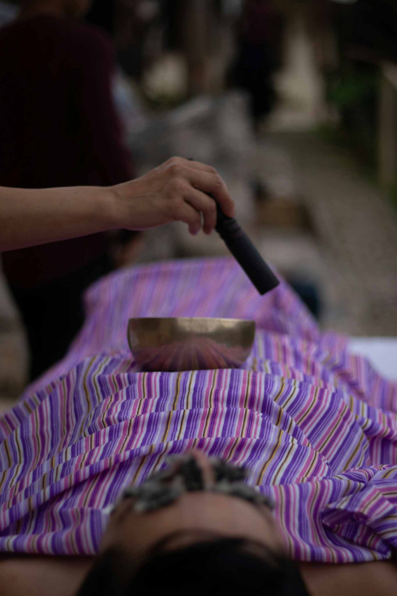 Sound healing session using a singing bowl placed on the chest, supporting emotional clarity and Wèi Qì regulation through vibrational medicine.